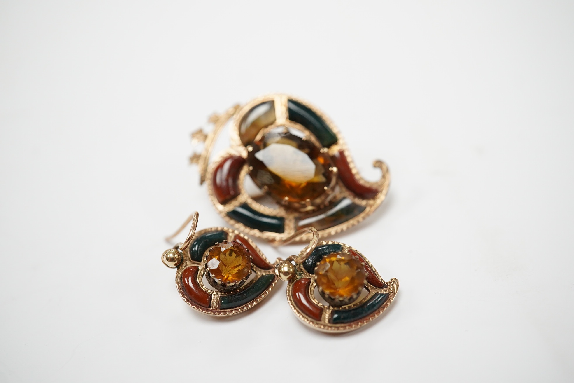 A yellow metal, Scottish hardstone and citrine set suite of jewellery, comprising a brooch, 30mm and pair of earrings, gross weight 7 grams. Condition - fair